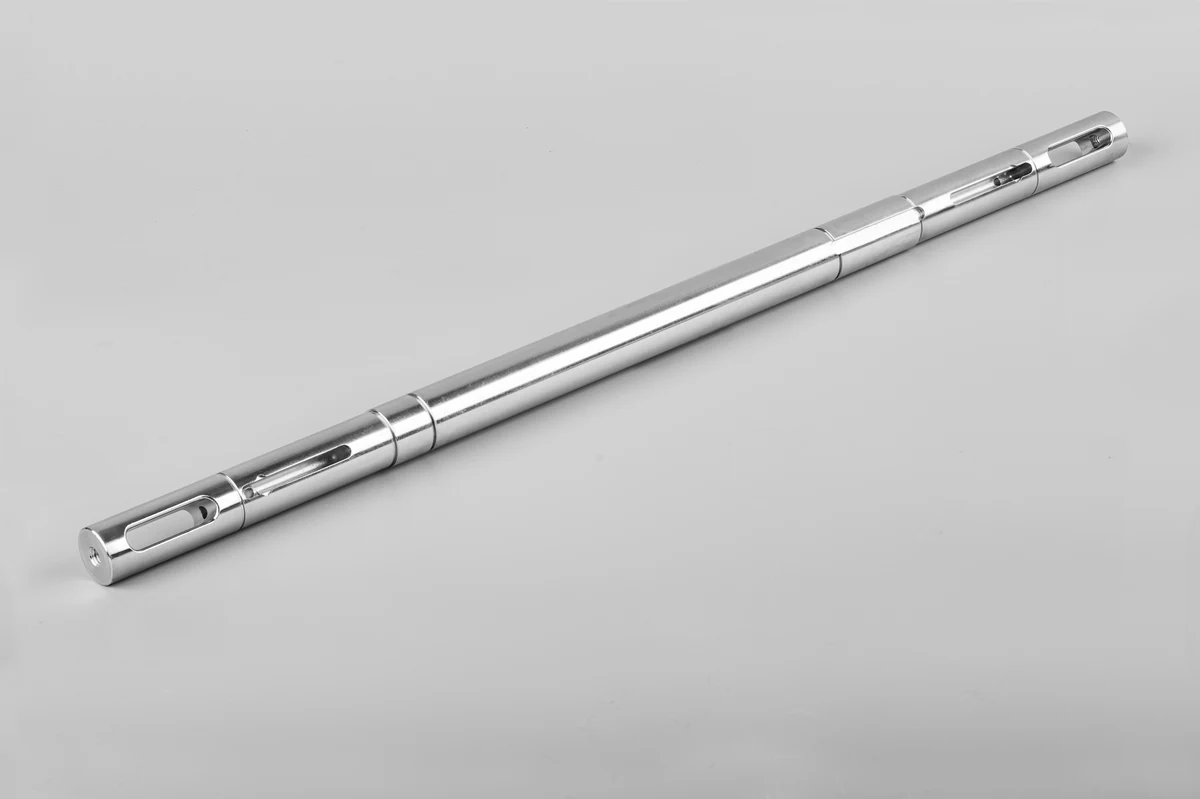 Long CNC turned steel shaft with machined keyways and slots along its length