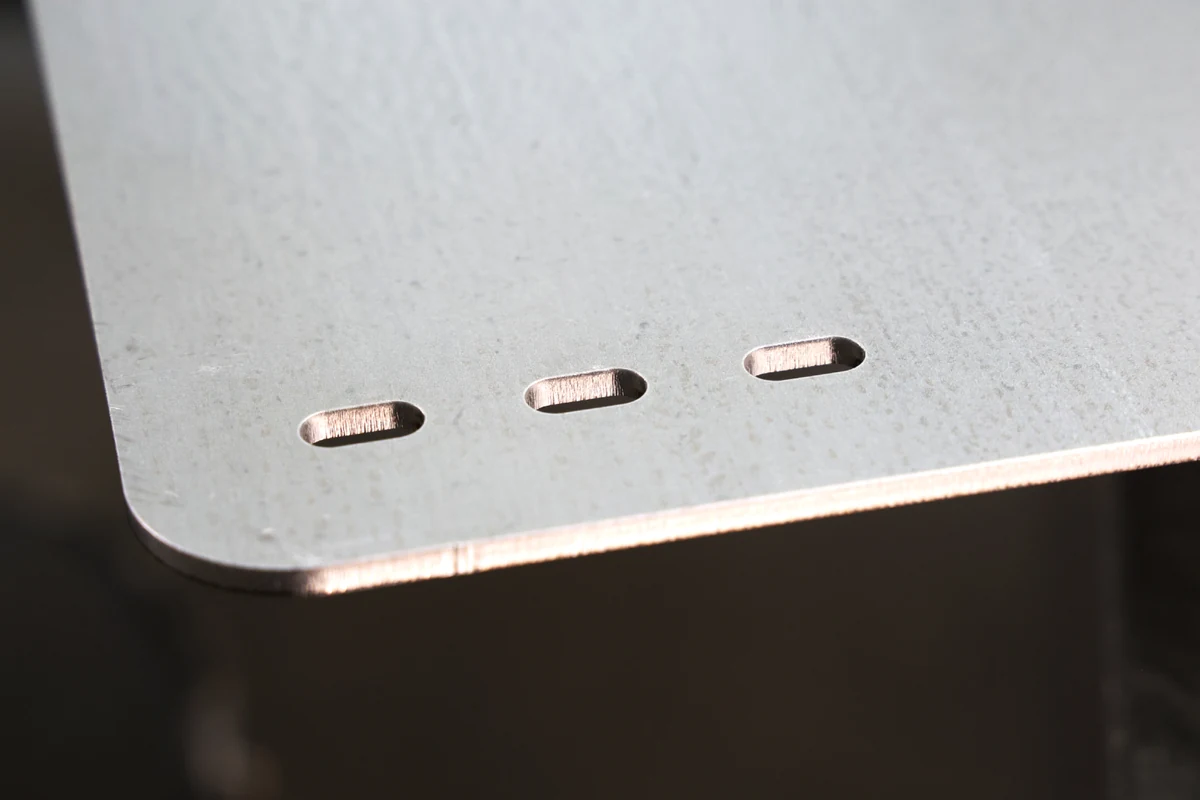 Laser cut slots and edge on galvanized SGCC steel panel showing bright cut edge