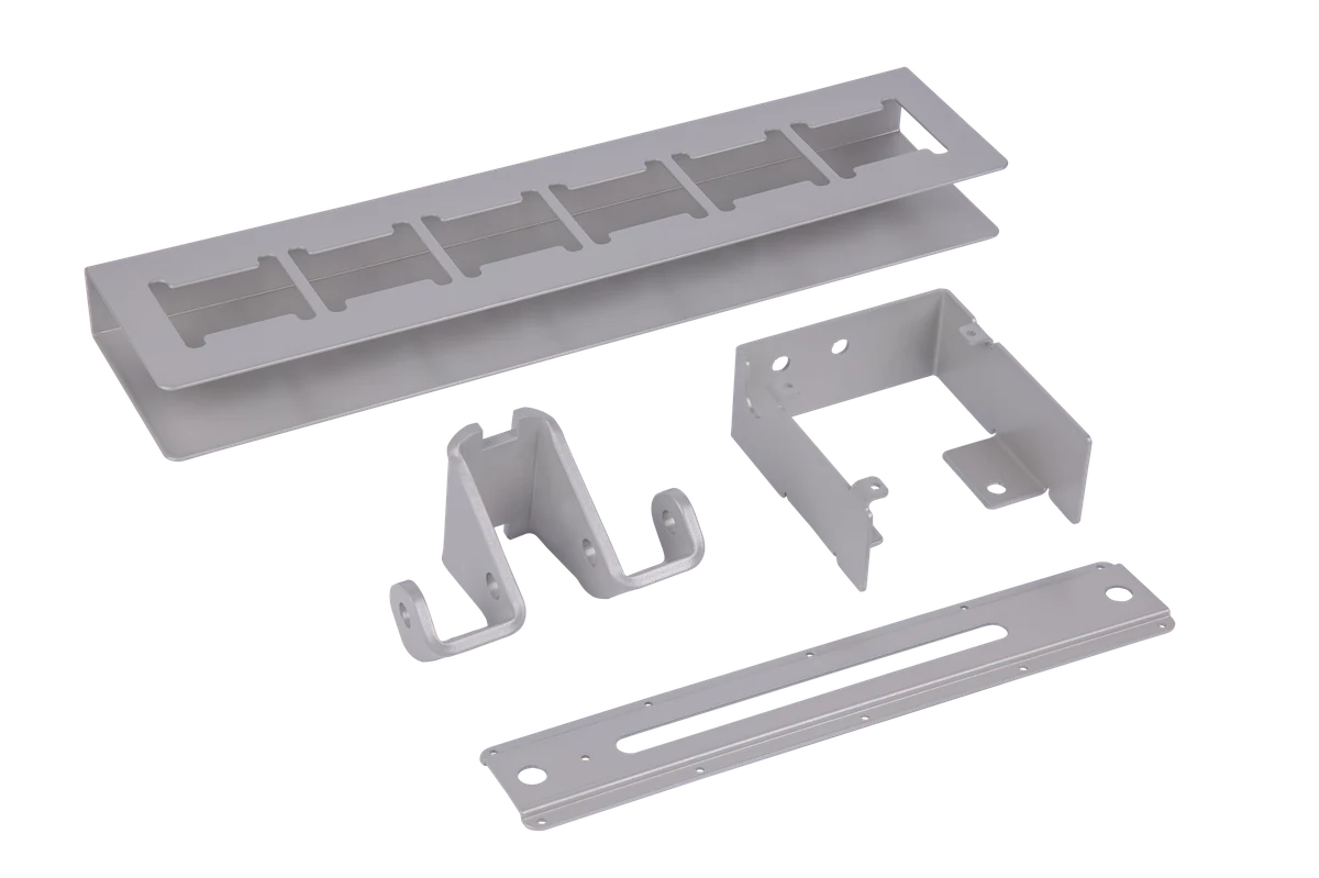 Assortment of laser cut aluminum parts including a channel, bracket, hook, and mounting plate