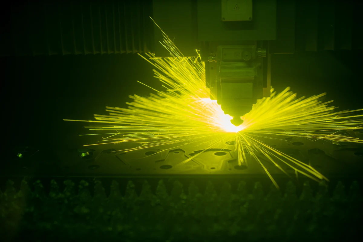 Laser cutting sheet metal, sparks flying from the beam path