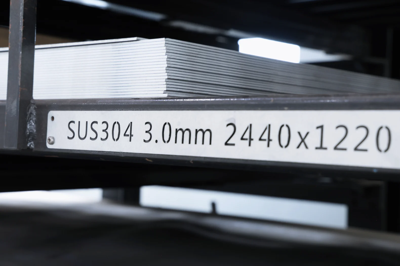 Stack of 3.0 mm SUS304 stainless steel sheet on a stock rack at Komacut